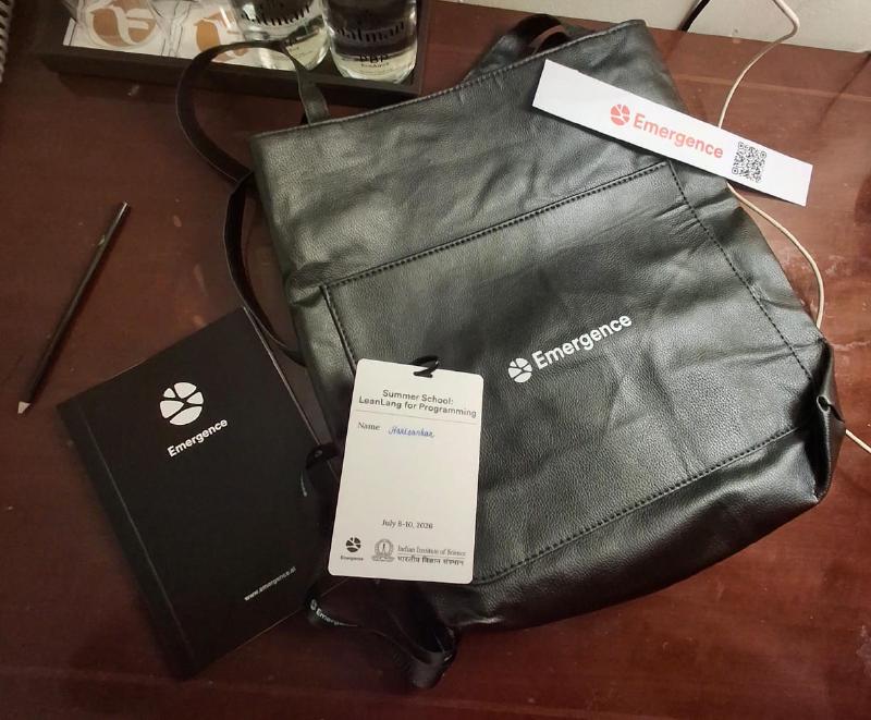 An Emergence tote bag, ID card, and summer-school merchandise